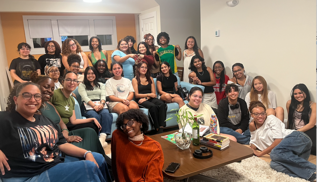 Diverse group of women of color sitting and posing for collective meeting
